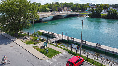 Overhead view of Front Street boat dock showing the dock wiht benches, the Welland River and bridge in the background that crosses the river..