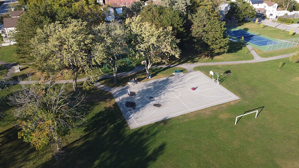 Drone photo of AJ McKinley Park showing the basketball court, soccer pitch, and tennis court.
